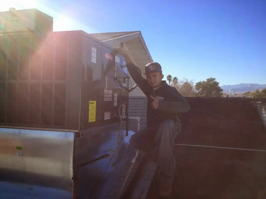 HVAC technician performing HVAC Inspection on a rooftop unit in Fair Lawn